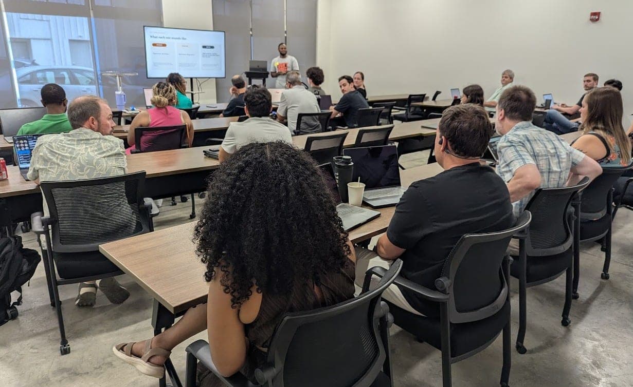 A full room at a recent AI meetup in Mobile, with Paul presenting